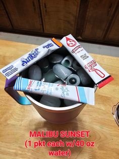 a bowl filled with different types of toothpaste on top of a wooden table