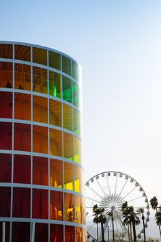 an amusement park with ferris wheel and palm trees