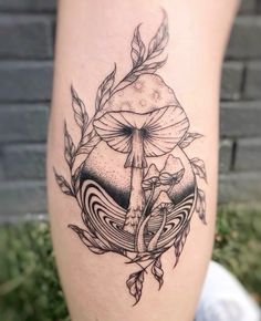 a woman's leg with a tattoo on it and an image of a mushroom