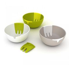 three bowls with forks and spoons sitting next to each other