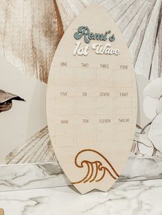 a wooden calendar sitting on top of a marble counter