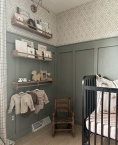 a baby's room with a crib, rocking chair and bookshelf