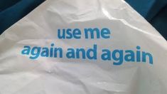 a paper bag with the words use me again and again written on it in blue