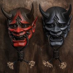 two black and red masks with horns on them