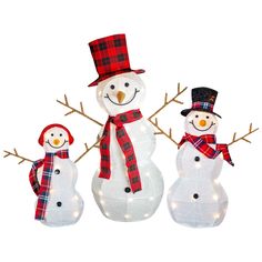 three lighted snowmen standing next to each other