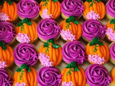 cupcakes decorated with purple frosting and orange flowers