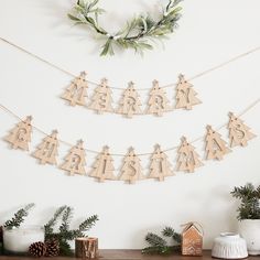 wooden christmas decorations on a mantle with greenery