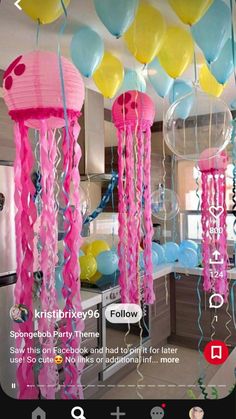 balloons and streamers are hanging from the ceiling in this party - like kitchen area