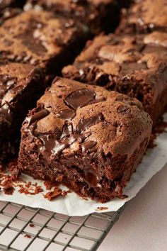 chocolate brownies on a cooling rack with one cut in half