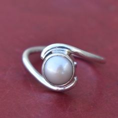 Beautiful Pearl Ring,Cultured South Sea Pearl Ring,Solid 925 Sterling Silver White Gemstone Ring,Handmade Jewelry,Promise Ring,Gift for her Gemstone : Pearl Stone Shape : Round Stone Color : White Stone Dimension (Approx) : 7 x 7 mm Ring Sizes : All Size Rings Available If you want to set the stones in 925 Solid Sterling Silver Like as earrings, pendant , Ring. I am always ready to make your custom design jewelry. Please contact me. --------------------------------------------------------------- Elegant Silver Crystal Ring With Simple Design, Adjustable Minimalist Sterling Silver Pearl Ring, White Bypass Ring As Gift, White Open Bypass Ring As Gift, White Open Bypass Ring For Gift, Classic Adjustable Bypass Ring For Gift, Solitaire Bypass Ring As A Gift, Solitaire Bypass Ring Gift, Elegant Silver Toe Ring Birthstone