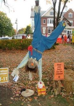 a scarecrow is doing a handstand in the yard