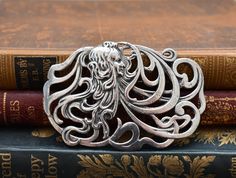 This is such a lovely original vintage brooch. It is very large at 3 inches across and is likely made of pewter.  It is an amazing design of a Mucha style Art Nouveau lady with incredible flowing locks in an open style, so she drapes across an outfit.  It has a good rear clasp and a solid weight and is a lovely and highly unusual statement piece. This would look gorgeous on an outfit and would make a lovely gift. As an item is this old, it will show signs of wear commensurate with age. Please examine the photographs carefully and do feel free to contact me with any questions, I am happy to help. Art Nouveau Lady, Art Nouveau Jewelry, Vintage Brooch, Style Art, Vintage Brooches, Lovely Gift, Favorite Jewelry, Brooch Pin, Statement Pieces