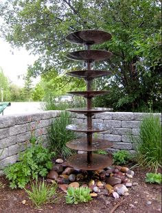 a water fountain in the middle of a garden