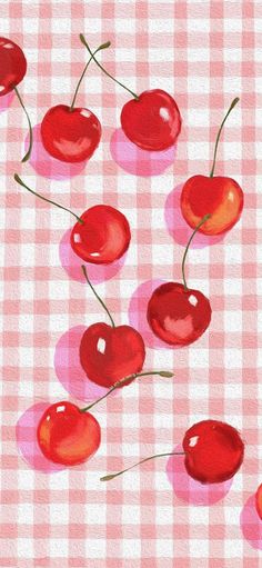 cherries are arranged on a checkered tablecloth