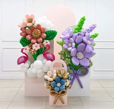 two vases with flowers and balloons in them