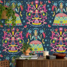 the wallpaper is decorated with colorful designs on it's blue background, and has potted plants in front of it