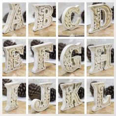 the letters are made from wood and have different designs on each letter, along with pine cones