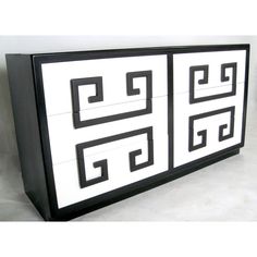 a black and white cabinet with two squares on the front, one in the middle