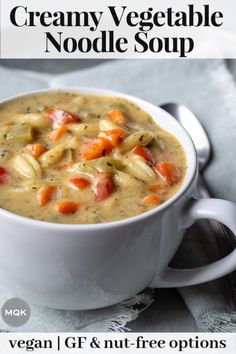 creamy vegetable noodle soup in a white bowl