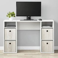 a white desk with two drawers and a computer monitor