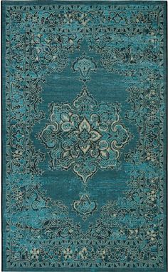 a blue rug with an ornate design on the front and back side, in various colors