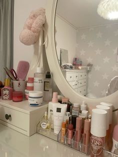 the vanity is full of cosmetics and beauty products