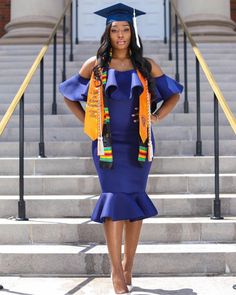 a woman wearing a graduation cap and gown standing in front of stairs with her hands on her hips