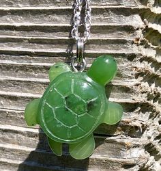 This smaller sized Canadian Jade Turtle pendant measures approximately 20mm in size. This pendant will come with or without a Sterling silver chain and will come complete with a hand crafted wooden gift box. All of our Jade is 100% natural. Turtles symbolize good health and long life.  View other products from JademineCanada here : https://www.etsy.com/ca/shop/JadeMineCanada?ref=hdr_shop_menu ** All purchases from outside of Canada are subject to duties and VAT fee's ------ Jade West has been mi Green Resin Pendant Necklace, Unique Green Carved Necklace, Small Handmade Green Jewelry, Green Resin Round Pendant Necklace, Jade Necklace With Lobster Clasp As A Gift, Handmade Small Green Jewelry, Jade Necklace With Lobster Clasp For Gift, Green Engraved Round Pendant Necklace, Jade West