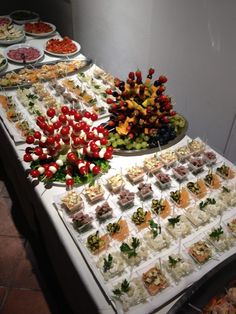 food is displayed on the table for people to eat it looks like they're getting married