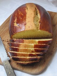 a loaf of bread on a cutting board with a knife