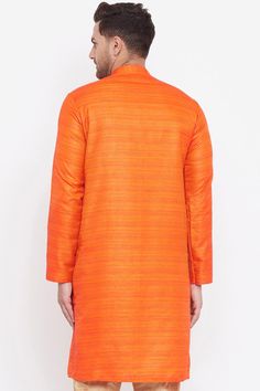 Orange matka silk straight knee length kurta in Earthy Colors, has a mandarin collar, button placket, long sleeves, straight hem and side slits. Product Features: Color: Orange Fabric: Blended Silk Work: Stripe Length: Long Kurta Sleeve: Full Sleeve Collar: Mandarin or Chinese Neck Closure Type/Placket: Button Shape Type: Regular Straight Occasion: Festive Care Instruction: Dry Clean preferably or cold light wash Disclaimer: There will be slight difference in digital to actual image Orange Kurta For Men, Striped Kurta, Grey Kurta, Kurta Top, Long Kurta, Men's Ethnic Wear, Colour Orange, Orange Fabric, Self Design