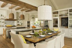 an image of a dining room and kitchen with pictures on the wall above it,