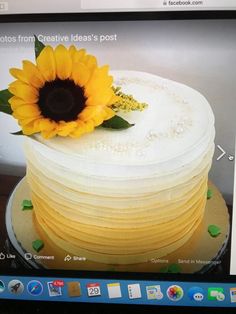 there is a yellow cake with a sunflower on top