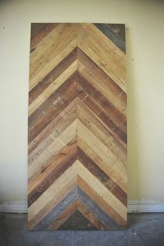 a skateboard that is leaning up against a wall with wood planks on it