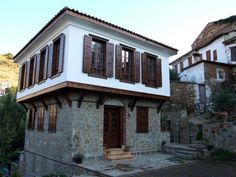 an old stone house with wooden shutters