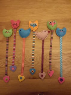 several colorful hair clips with birds and hearts on them