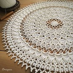 a crocheted doily is laying on the floor