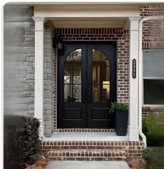 a black front door on a brick house