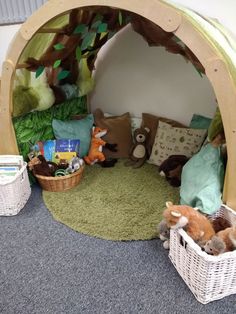 a child's play area with stuffed animals and toys in baskets on the floor