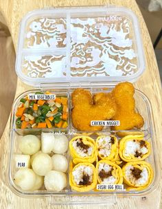 a plastic container filled with food on top of a wooden table