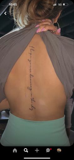 the back of a woman's neck with an inscription on her lower back and upper arm