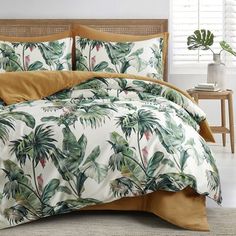 a bed covered in a white and green comforter