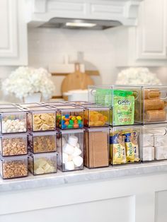 the kitchen counter has many containers with food in them