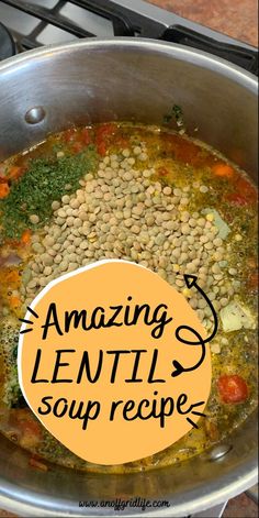 a pot filled with beans and vegetables on top of a stove next to a sign that says amazing lentils soup recipe