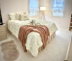 a bedroom with a bed, dresser and window