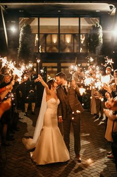 a newly married couple holding sparklers in their hands