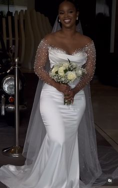 a woman in a white wedding gown holding a bouquet