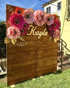 a wooden sign that has flowers on it