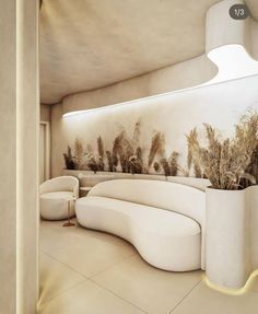 an artisticly designed living room with white furniture and plants on the wall behind it