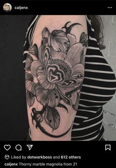 a woman's arm with black and white flowers on the left side of her body